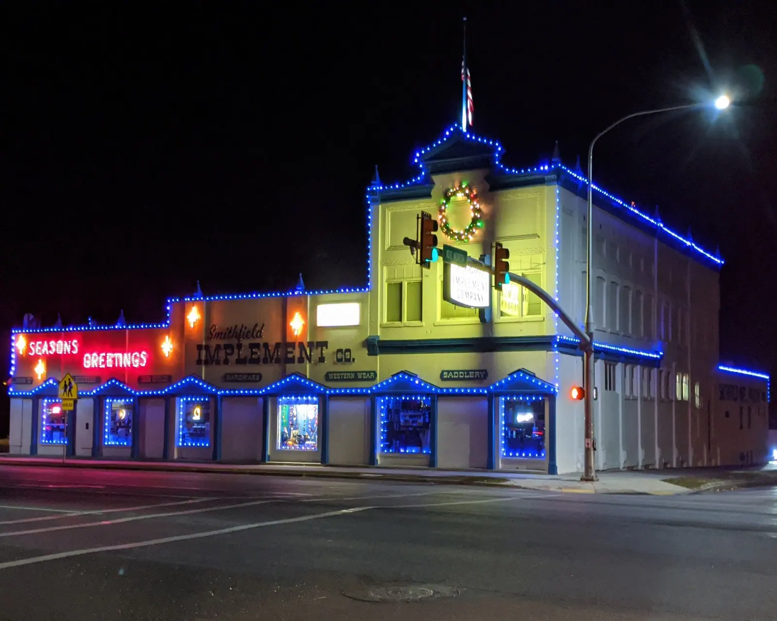 The storefront outlined in lights at night
